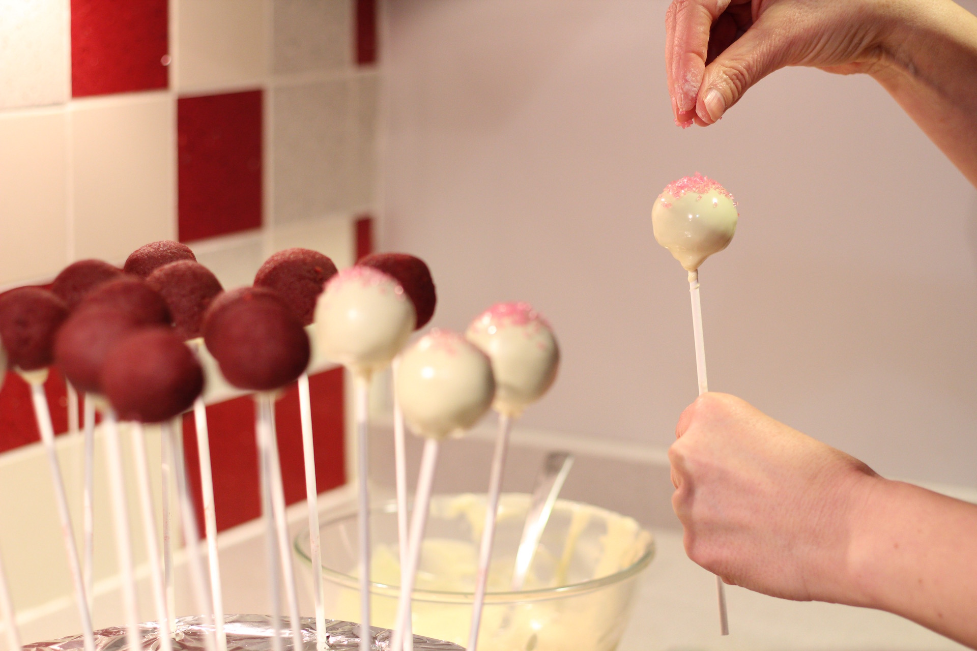 poniendo azúcar coloreado en las cake pops